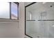 Contemporary shower with a black frame, marble-look tile, and modern fixtures at 8809 Beach Front Dr, Las Vegas, NV 89117