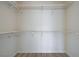 Bright walk-in closet with white walls, wire shelving and modern wood flooring at 8809 Beach Front Dr, Las Vegas, NV 89117