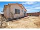 Backyard with minimal landscaping and stucco wall. Perfect for personalization at 8944 W Rochelle Ave, Las Vegas, NV 89147