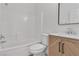 Clean bathroom featuring a shower/tub combo, stylish sink with decorative cabinets, modern faucet, and white tile at 8944 W Rochelle Ave, Las Vegas, NV 89147