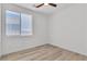 Bright bedroom features modern light-tone wood-look floors and a window for ample natural light at 8944 W Rochelle Ave, Las Vegas, NV 89147