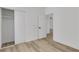 Bedroom features wood-look floors, closet, and open doorway into another room at 8944 W Rochelle Ave, Las Vegas, NV 89147