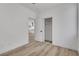 Bedroom with wood-look floors, closet and an open doorway into the modern kitchen at 8944 W Rochelle Ave, Las Vegas, NV 89147