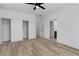 Bright bedroom with wood-look floors, a ceiling fan, closet, and doorway at 8944 W Rochelle Ave, Las Vegas, NV 89147