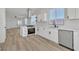 Bright open kitchen boasts stainless steel appliances, quartz countertops, stylish cabinetry and durable wood-look floors at 8944 W Rochelle Ave, Las Vegas, NV 89147