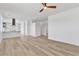 Bright living room featuring durable wood-look floors and an open layout flowing into the kitchen at 8944 W Rochelle Ave, Las Vegas, NV 89147