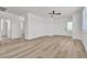 Spacious living room with durable wood-look floors, ceiling fan, fresh paint, and ample natural light at 8944 W Rochelle Ave, Las Vegas, NV 89147
