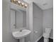 Powder room featuring pedestal sink and toilet at 901 Carnival Ave, Las Vegas, NV 89123
