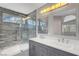 Modern bathroom features double sinks, updated tile, a shower-tub combo, and lots of light at 901 Carnival Ave, Las Vegas, NV 89123