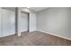 A cozy bedroom with neutral walls and carpet and featuring a convenient closet with sliding doors at 901 Carnival Ave, Las Vegas, NV 89123