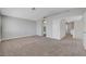 A neutral bedroom offers carpet, gray walls, and an archway leading to the modern bathroom at 901 Carnival Ave, Las Vegas, NV 89123