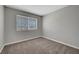 Bright bedroom features gray walls, neutral carpet, and a large window at 901 Carnival Ave, Las Vegas, NV 89123