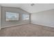 The spacious bedroom boasts neutral carpet, vaulted ceiling, and natural light from the windows at 901 Carnival Ave, Las Vegas, NV 89123
