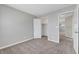 A neutral bedroom offers carpet, gray walls, and a doorway to the closet and hallway at 901 Carnival Ave, Las Vegas, NV 89123
