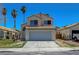 Inviting two-story home featuring a tile roof, desert landscaping, and attached two-car garage at 901 Carnival Ave, Las Vegas, NV 89123