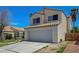 Side view of the property with a tile roof and spacious two-car garage, complemented by desert landscaping at 901 Carnival Ave, Las Vegas, NV 89123