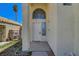 Home featuring an arched window above a white front door and drought resistant landscaping at 901 Carnival Ave, Las Vegas, NV 89123