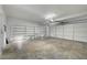 Spacious garage with ample storage shelving and a large door, perfect for organization at 901 Carnival Ave, Las Vegas, NV 89123