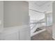 Bright hallway with stairs, white banister, and carpeted floor, leading to the upper level at 901 Carnival Ave, Las Vegas, NV 89123