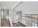 Bright hallway with white railing overlooking the stairs to the first floor and bedrooms beyond at 901 Carnival Ave, Las Vegas, NV 89123
