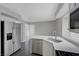 Bright kitchen features stainless appliances, white cabinetry and countertops, and gray flooring at 901 Carnival Ave, Las Vegas, NV 89123