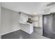 Bright kitchen features white cabinetry, stainless microwave, and gray flooring at 901 Carnival Ave, Las Vegas, NV 89123
