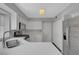 Bright kitchen features stainless appliances, white cabinetry and countertops, plus lots of light at 901 Carnival Ave, Las Vegas, NV 89123