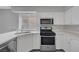 Bright kitchen features stainless steel appliances, light countertops, and white cabinetry at 901 Carnival Ave, Las Vegas, NV 89123