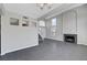 Spacious living room boasts neutral walls, tiled floors, fireplace, and staircase at 901 Carnival Ave, Las Vegas, NV 89123