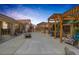 Wide backyard showcasing a spacious patio, pergola covered dining area, and cozy fire pit setting at 9015 S Tenaya Way, Las Vegas, NV 89113