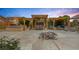 Expansive backyard featuring a pergola, fire pit, outdoor seating, and built-in grill, perfect for entertaining at 9015 S Tenaya Way, Las Vegas, NV 89113