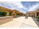 Spacious backyard featuring an outdoor kitchen, dining area, lounging space, and fire pit at 9015 S Tenaya Way, Las Vegas, NV 89113