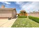 This backyard has a cozy deck area covered by an umbrella, perfect for relaxing at 9015 S Tenaya Way, Las Vegas, NV 89113