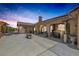 Open backyard with a covered patio, outdoor bar area, and space for lounging and grilling at 9015 S Tenaya Way, Las Vegas, NV 89113