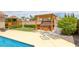 Relax in this backyard featuring a spa under a pergola and a sparkling pool at 9015 S Tenaya Way, Las Vegas, NV 89113