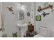 Unique bathroom features a pedestal sink, decorative frog-themed art and décor at 9015 S Tenaya Way, Las Vegas, NV 89113