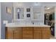 Bright bathroom with a double vanity, framed mirrors, and a view into a walk-in closet at 9015 S Tenaya Way, Las Vegas, NV 89113