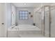 Serene bathroom featuring a glass shower, a soaking tub with marble accents, and tasteful décor at 9015 S Tenaya Way, Las Vegas, NV 89113