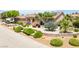 Beautiful home features lush landscaping, arched windows, and a tile roof at 9015 S Tenaya Way, Las Vegas, NV 89113
