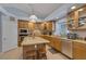 Well-lit kitchen features an island with granite countertops and stainless steel appliances at 9015 S Tenaya Way, Las Vegas, NV 89113