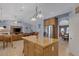 Open concept kitchen featuring a central island, wood cabinetry, and stainless steel appliances at 9015 S Tenaya Way, Las Vegas, NV 89113