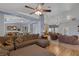 Large living room with a ceiling fan, and an archway leading to dining room at 9015 S Tenaya Way, Las Vegas, NV 89113
