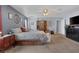 Relaxing main bedroom with a ceiling fan, an ensuite bathroom, and carpeted floors at 9015 S Tenaya Way, Las Vegas, NV 89113