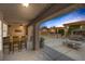 Desirable outdoor living space featuring a covered bar, grill, dining area, and a fire pit at 9015 S Tenaya Way, Las Vegas, NV 89113