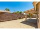 Large backyard featuring desert landscaping, block wall fencing, and a covered patio at 902 Possum Hill St, Henderson, NV 89014