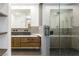 Modern bathroom featuring a wood vanity, vessel sink, and glass-enclosed shower at 902 Possum Hill St, Henderson, NV 89014