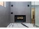 Bathroom with marble vanity and wall, including fireplace and glass shower entrance at 902 Possum Hill St, Henderson, NV 89014