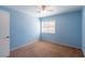 Bedroom featuring light blue walls, neutral carpet, a ceiling fan, and bright natural light at 902 Possum Hill St, Henderson, NV 89014