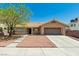 Inviting single-story house has desert landscaping, mature tree, and an attached two-car garage at 902 Possum Hill St, Henderson, NV 89014