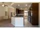 Open concept kitchen with dark wood cabinets, granite countertops, and stainless steel appliances at 902 Possum Hill St, Henderson, NV 89014